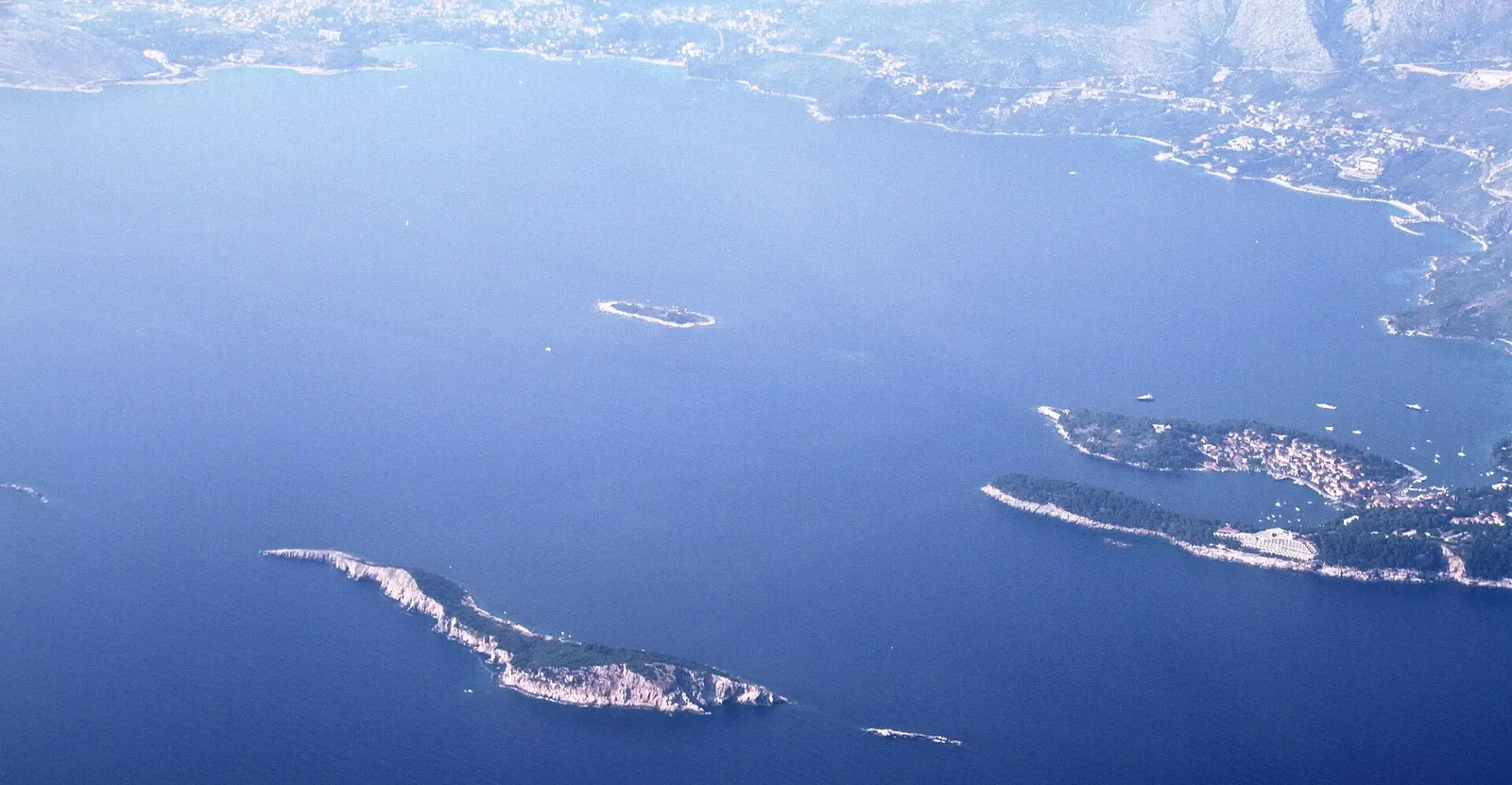 Aerial view of the Cavtat coast and nearby rocky islands separated by open water.