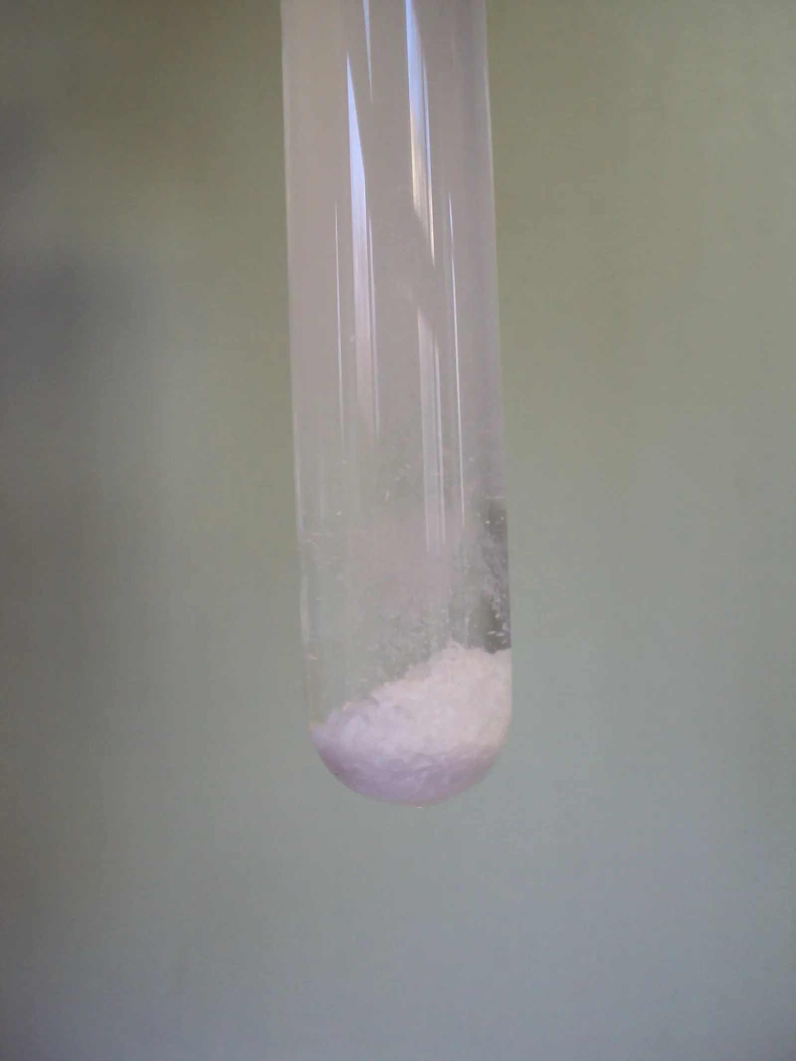 Pale silver chloride precipitate at the bottom of a modern glass test tube.