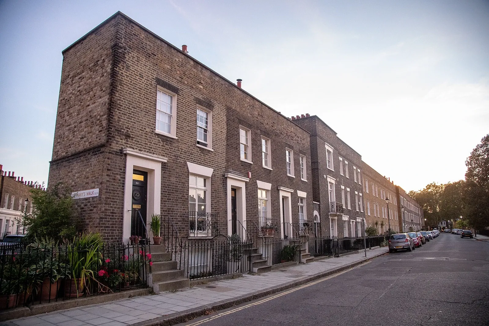 A row of neighboring brick houses in Walcot Square, Lambeth, seen in a modern photograph.
