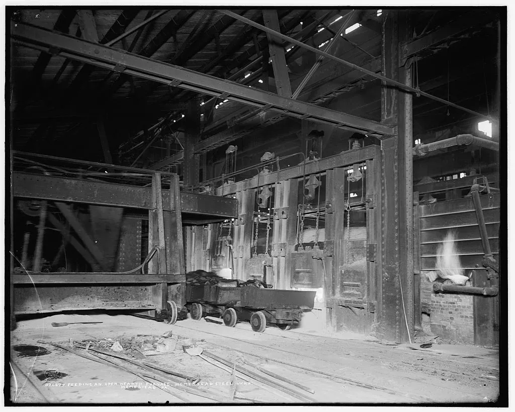 An open-hearth furnace and charging equipment inside Homestead Steel Works, Pennsylvania, photographed in 1908.