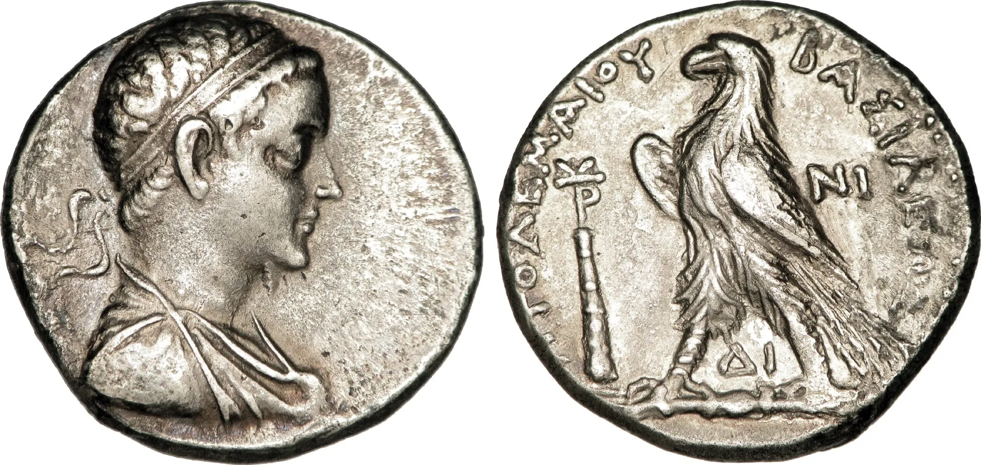 Both complete sides of a silver coin of Ptolemy V, showing a royal portrait and an eagle with Greek lettering.