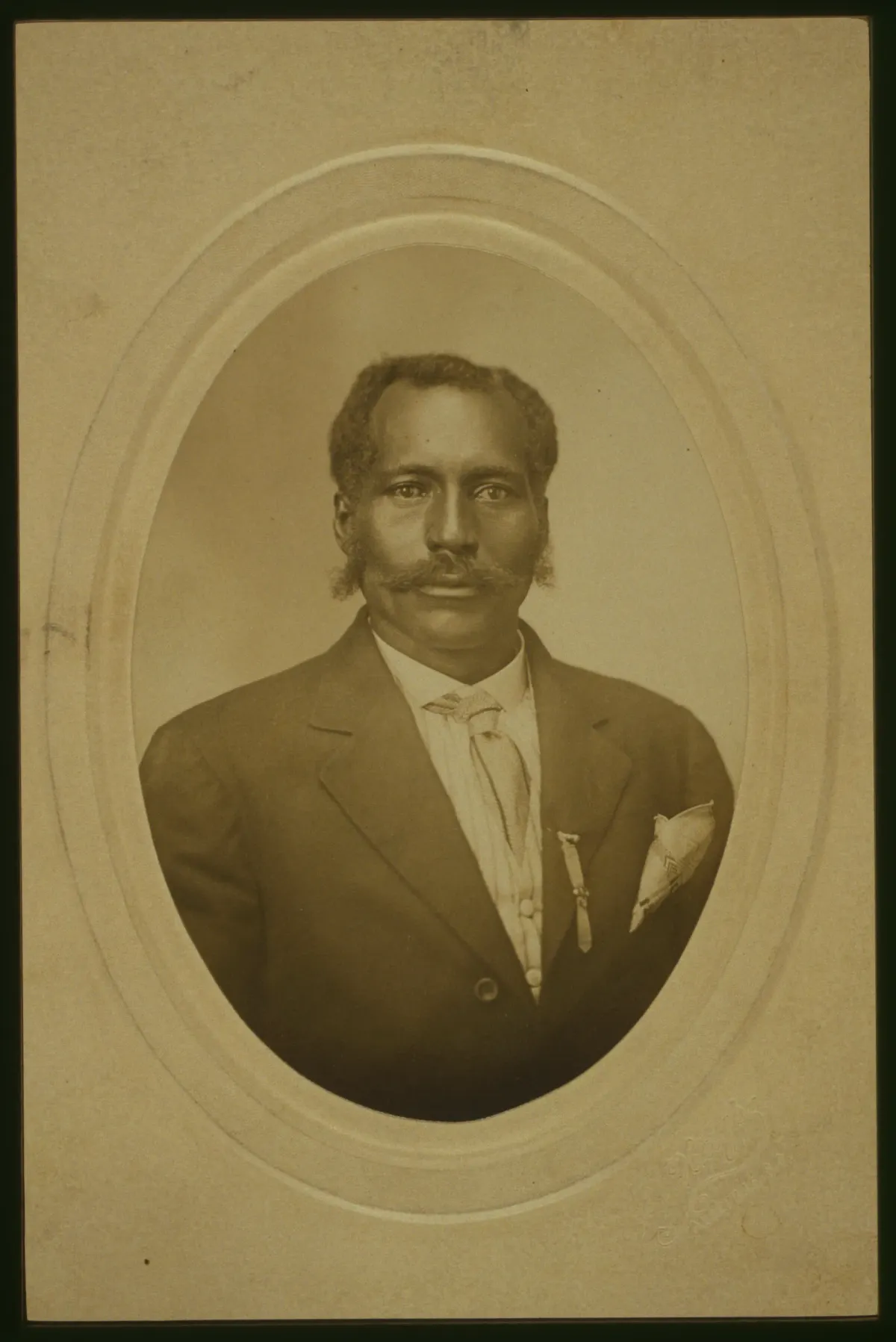 Anthony Crawford wearing a dark jacket, high-collared shirt and tie in a studio portrait, circa 1910.