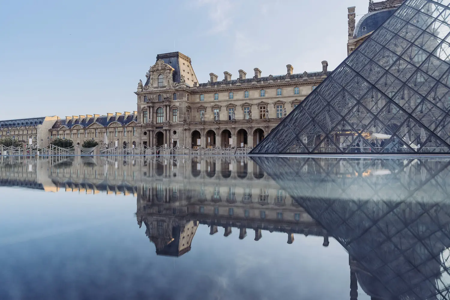 Louvre Museum and its iconic glass pyramid in Paris, France