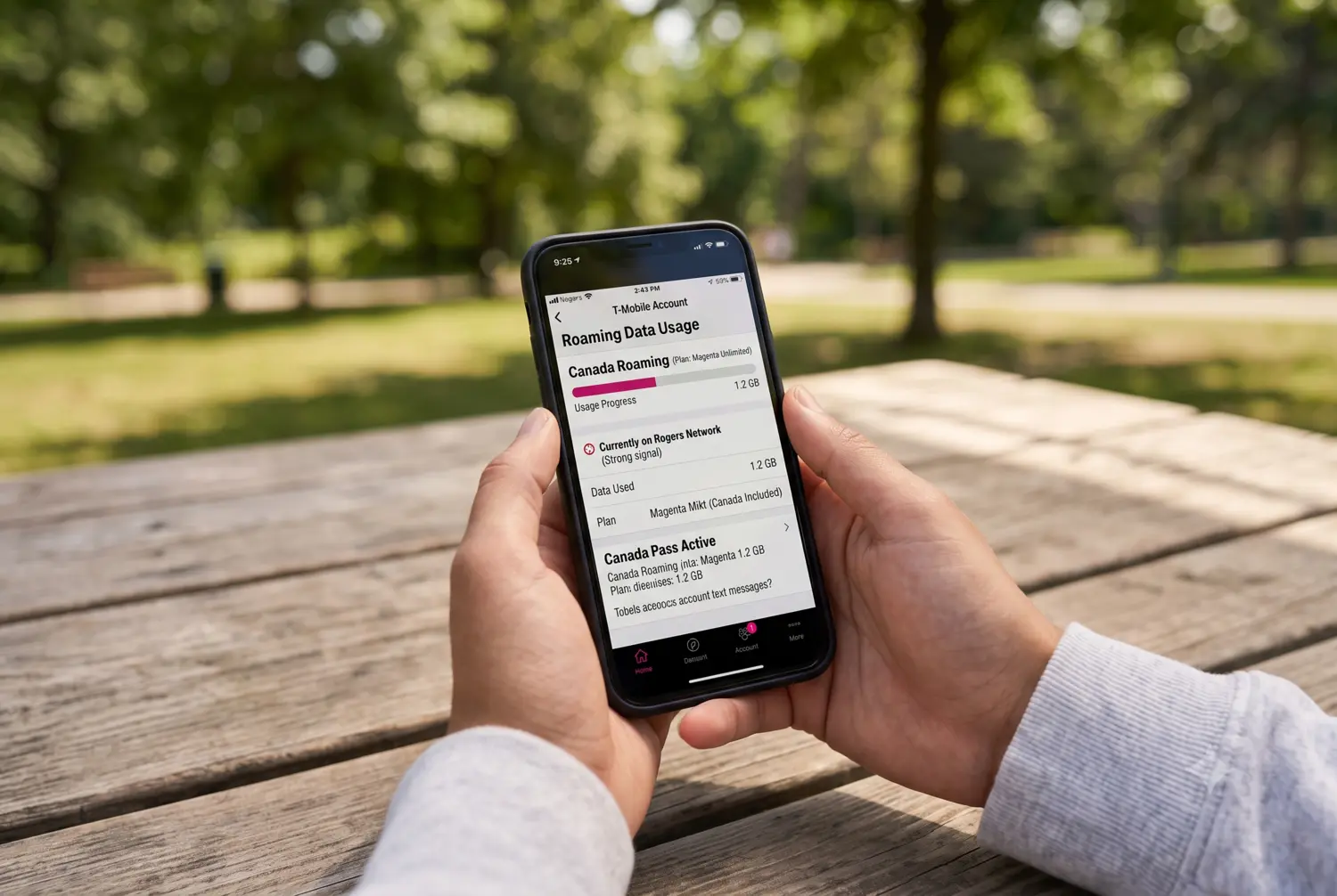 A person holding a smartphone with a T-Mobile account screen displaying "Canada Roaming" data usage