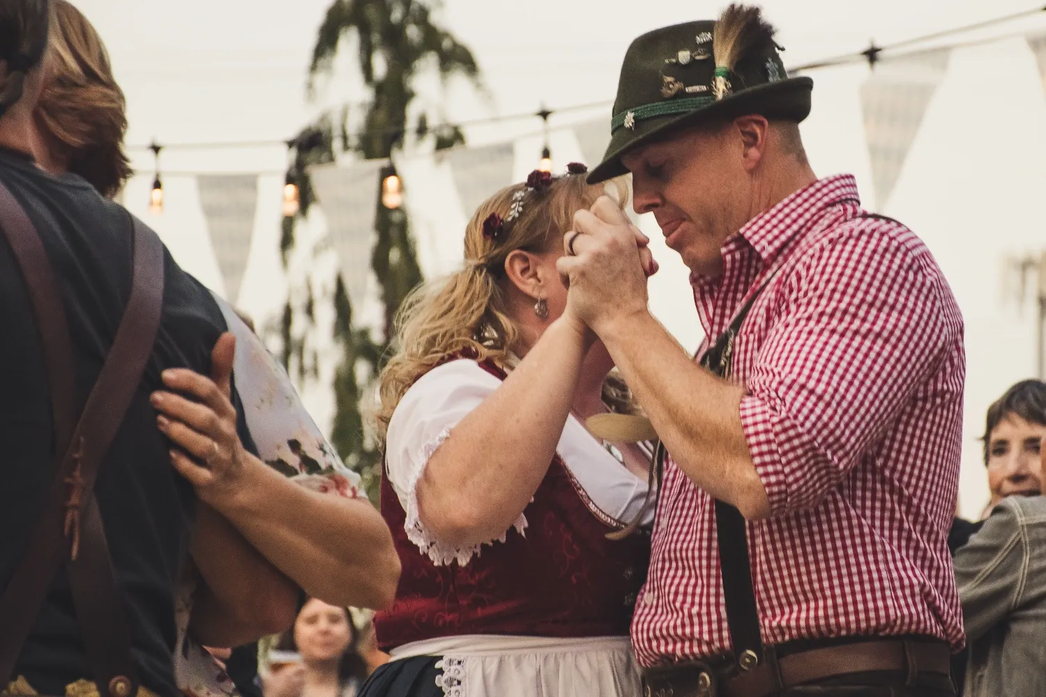 Oktoberfest celebration outdoors, wearing traditional attire