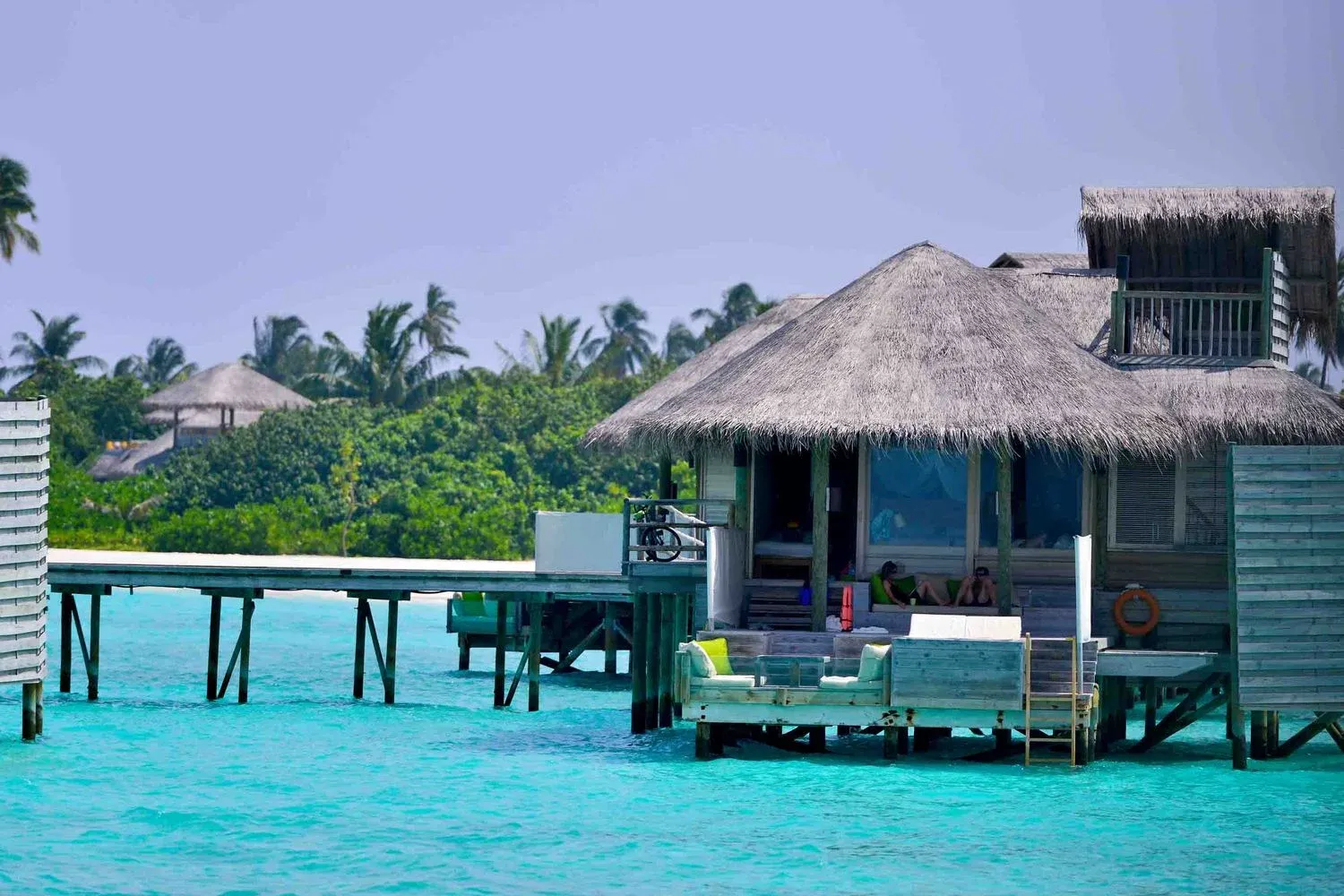 Overwater bungalows above turquoise lagoon water, Maldives