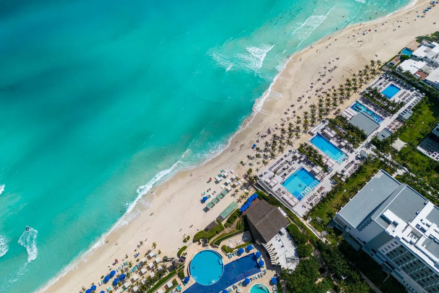 Top view of a Cancun beach resort with turquoise water and sandy shore