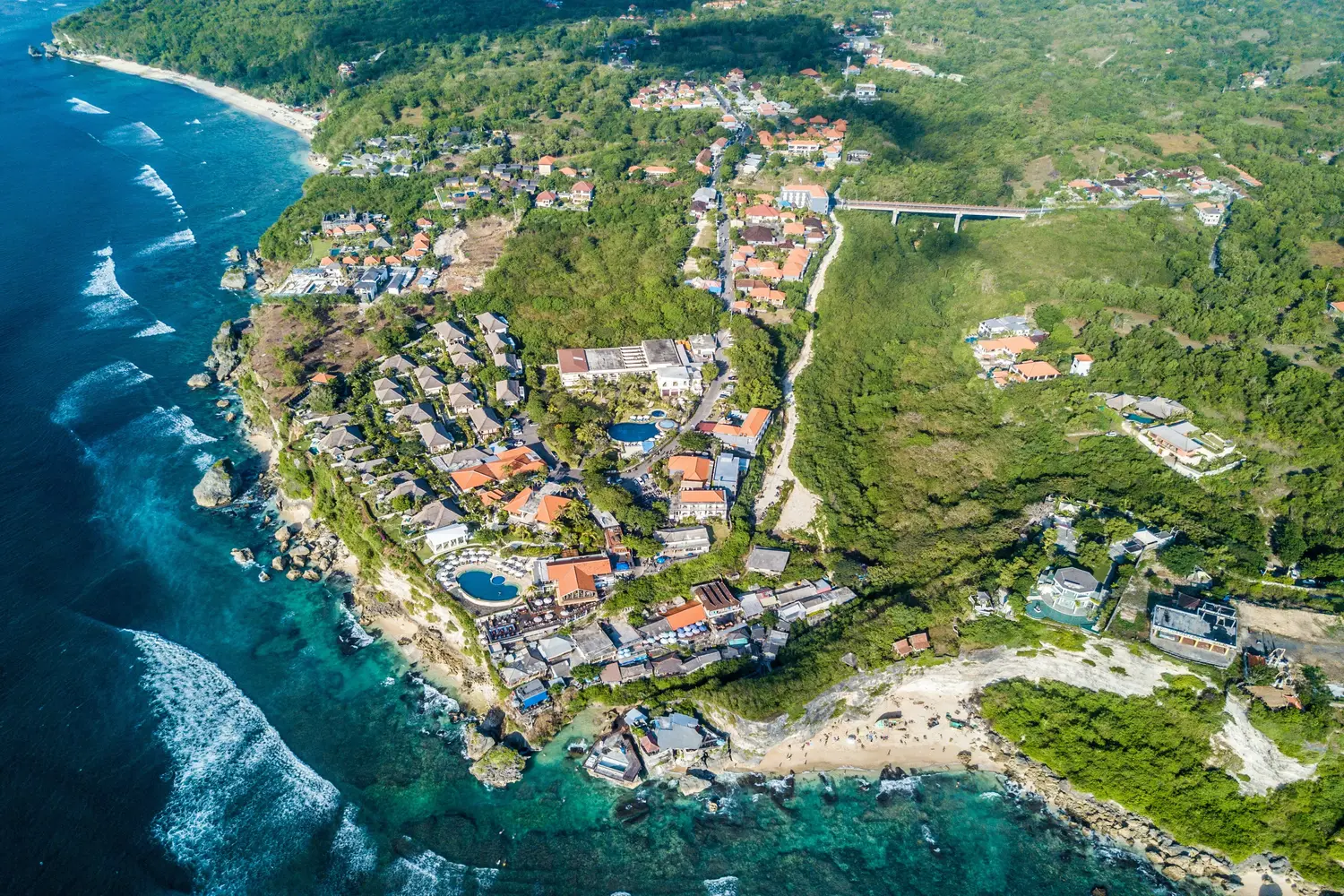 Aerial view of the coastal cliffs and resorts along the Bukit Peninsula in Uluwatu, Bali, Indonesia