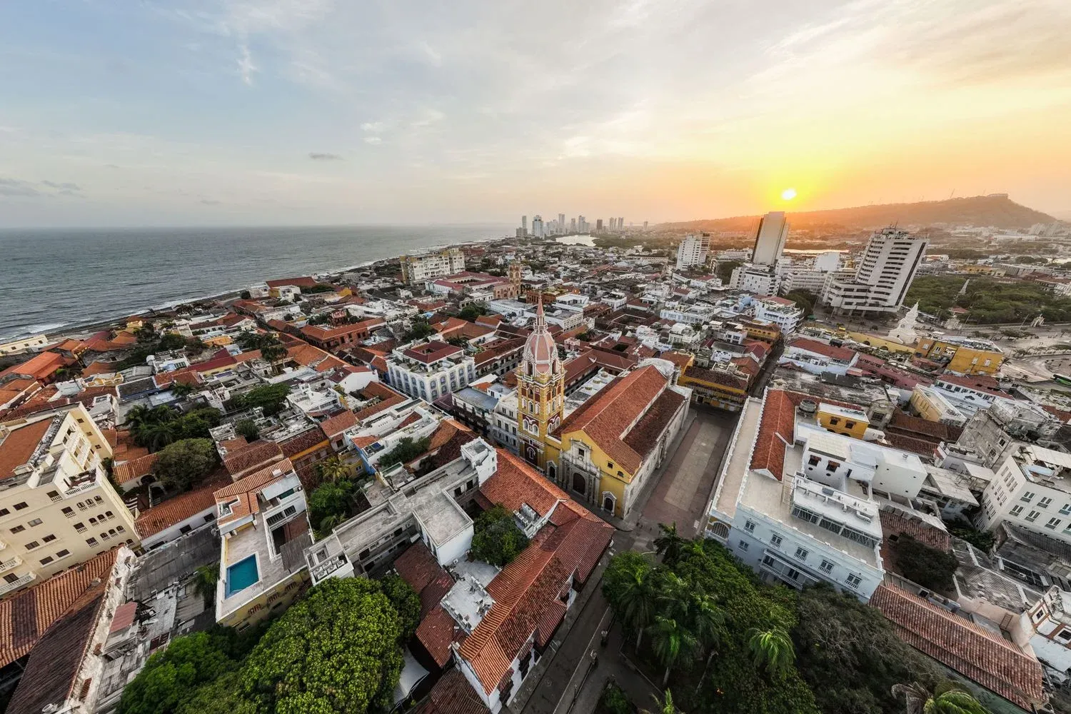 Aerial shot of Cartagena's historic district at sunset with vibrant architecture and ocean view