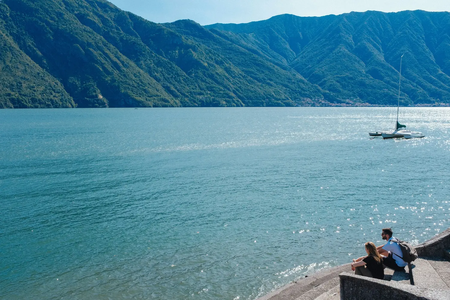 Couple Relaxing on the Wall by the Lake