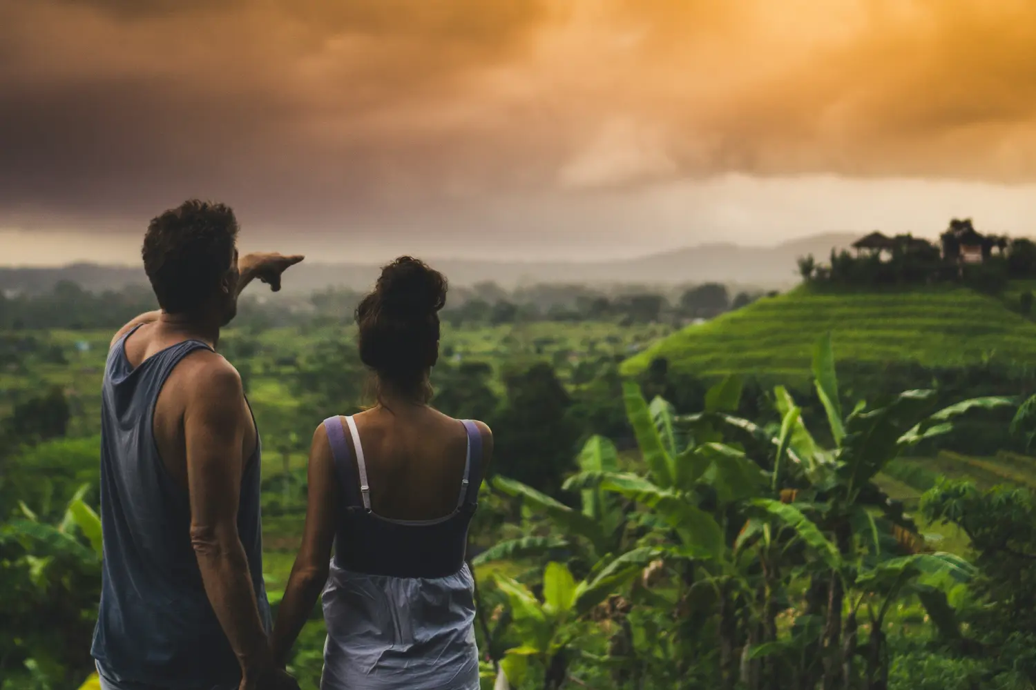 Couple looking at lush rice fields in Sidemen village, Bali