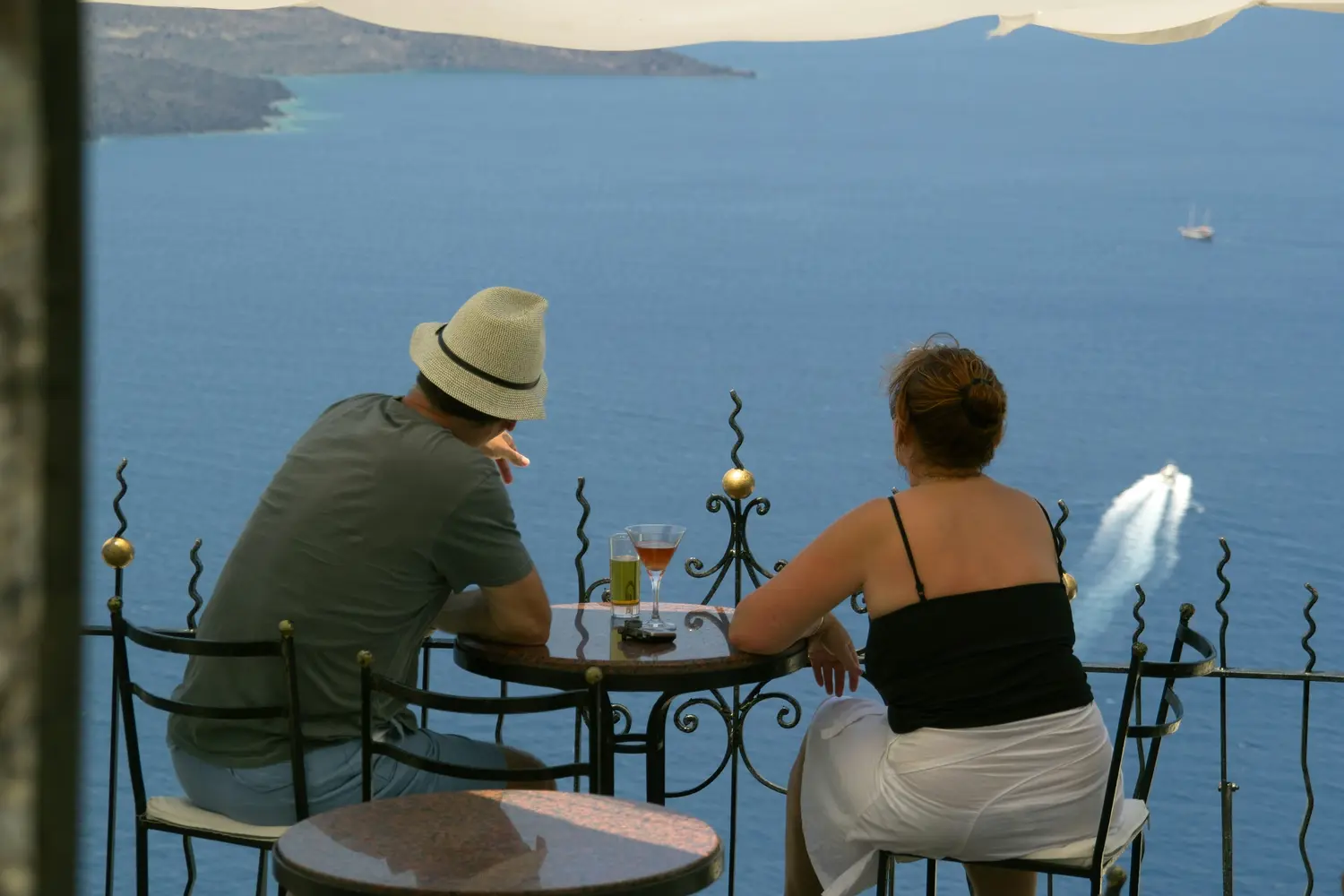 A Couple Dining Overlooking the Blue Sea