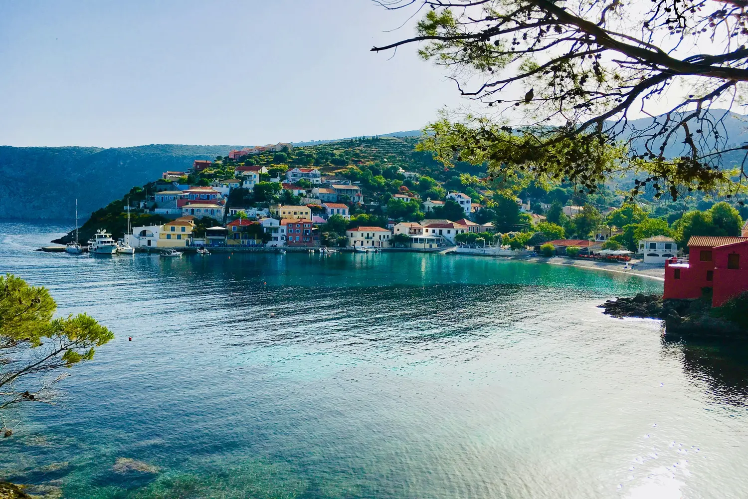 Village of Assos nestled on a lush green hillside on the island of Kefalonia in Greece