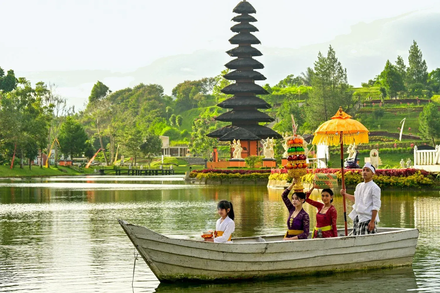Balinese ceremony with locals on a boat near a temple in Bali, Indonesia