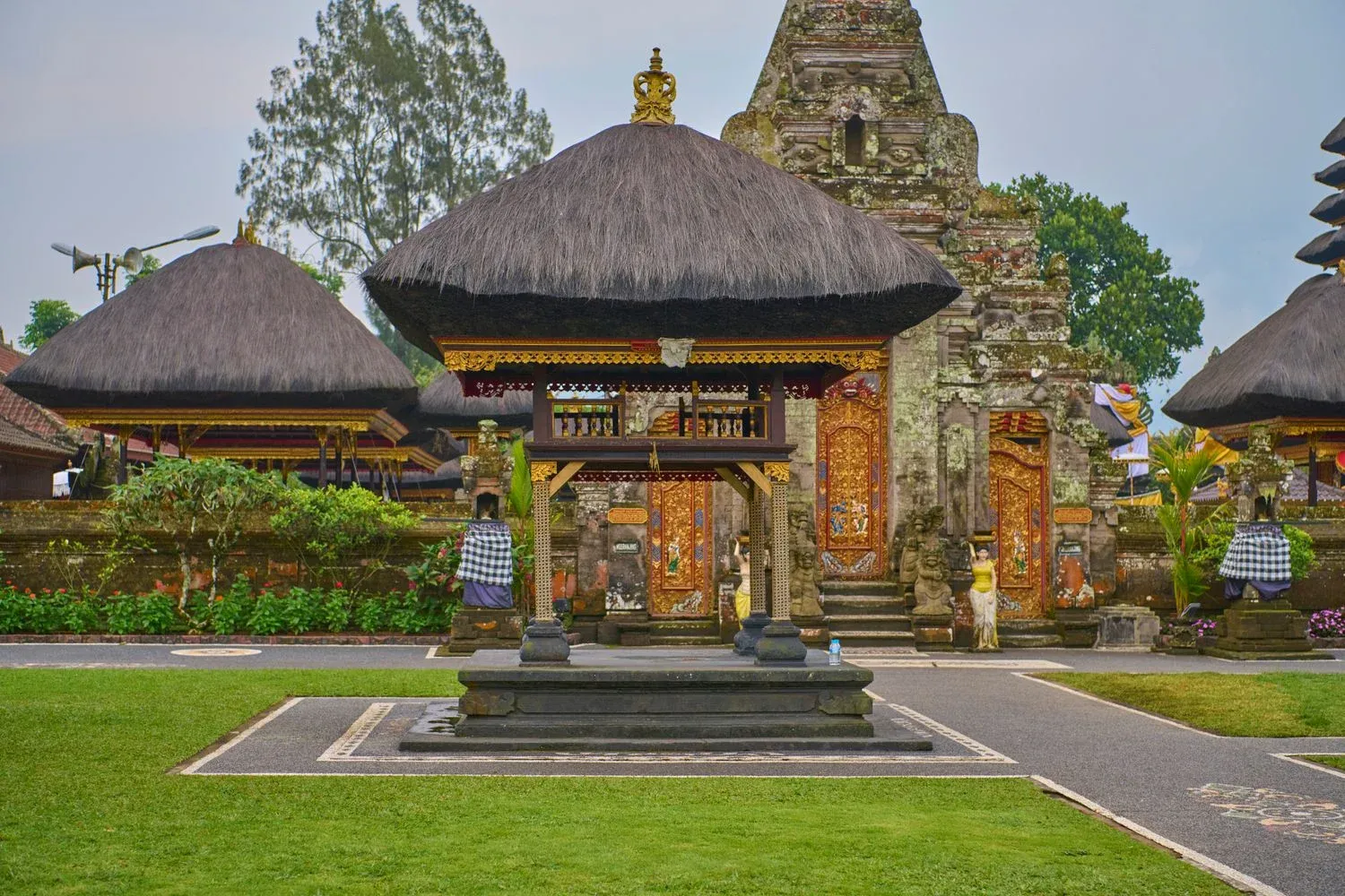 Balinese temple featuring traditional thatched roofs and intricate carvings