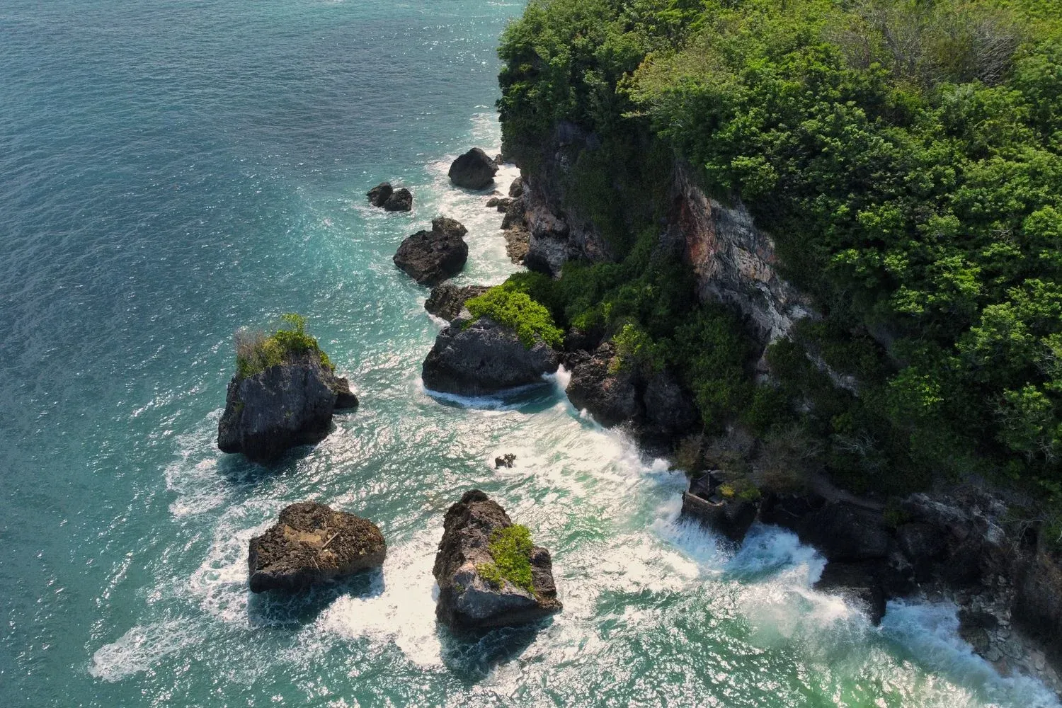 Rocky coastline with lush greenery in Bali, Indonesia
