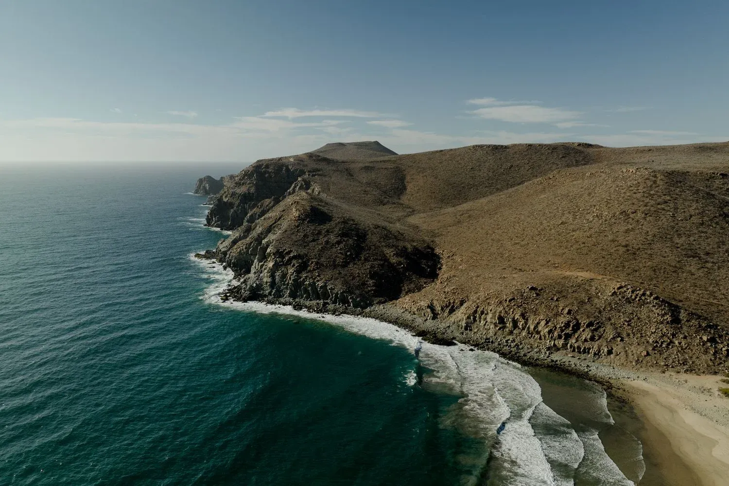 View of the rugged cliffs and serene beach at Todos Santos, Mexico
