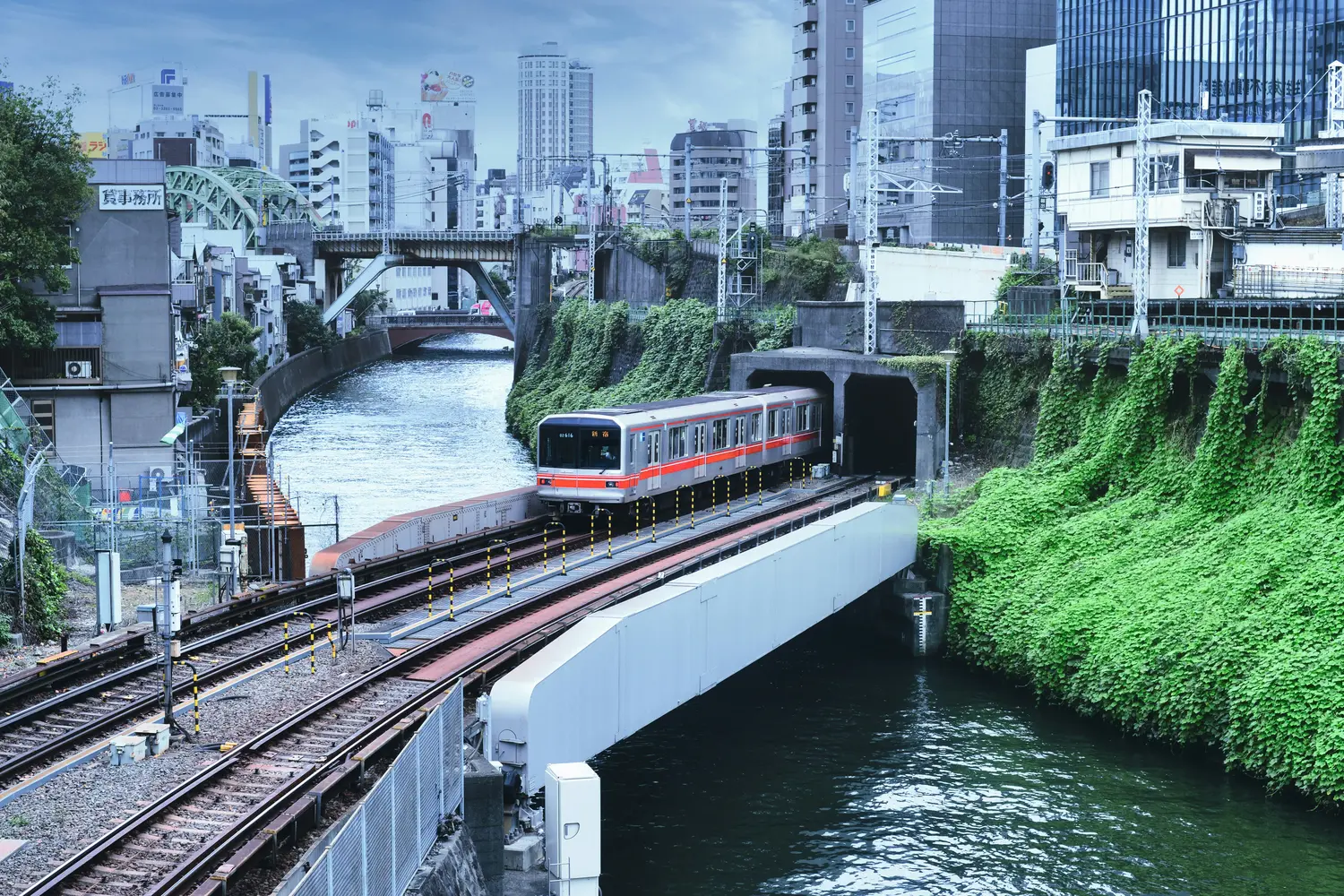 Tokyo Metro Marunouchi Line train exiting a tunnel near Ochanomizu Station in Chiyoda, Tokyo, Japan