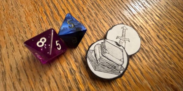 Two 8-sided dice and two tokens (one with a sword and one with tomes)