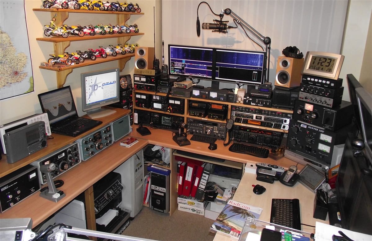 Very highly dense and technical desk full of radio equipment