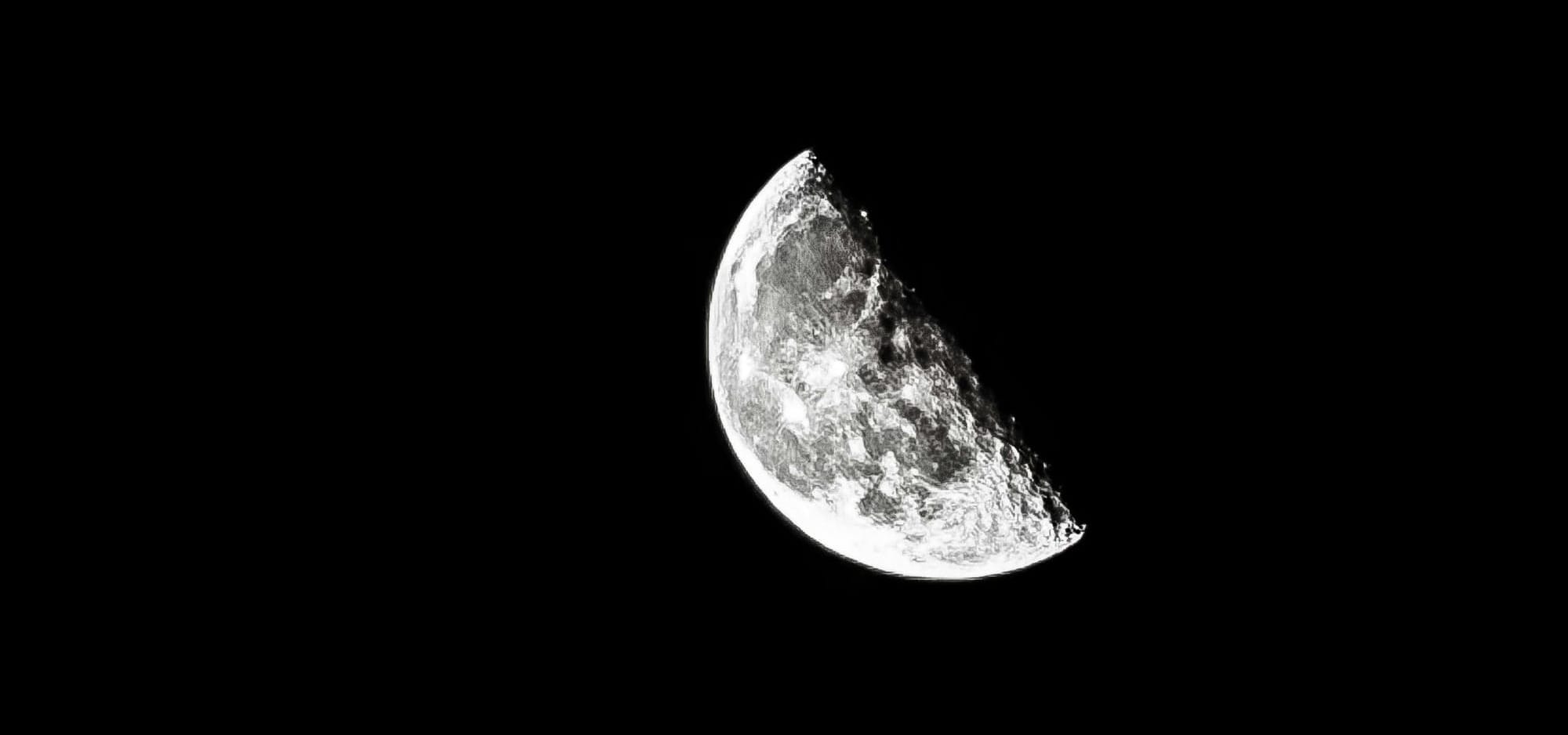 Half Moon in Night Sky with Craters Visible