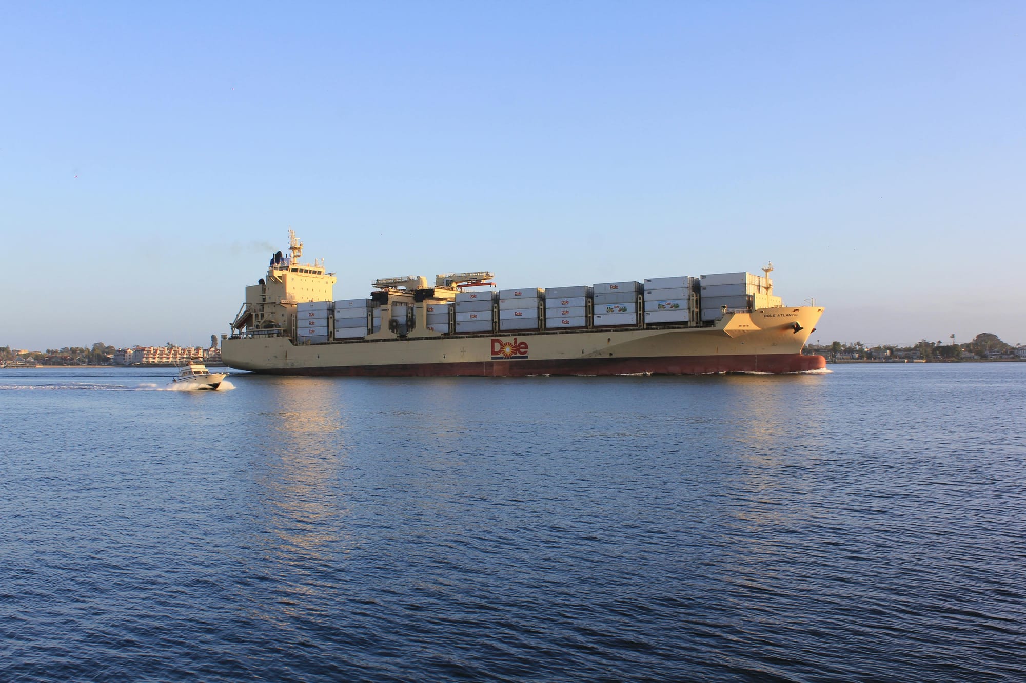 Cargo Ship on Water Under the Blue Sky