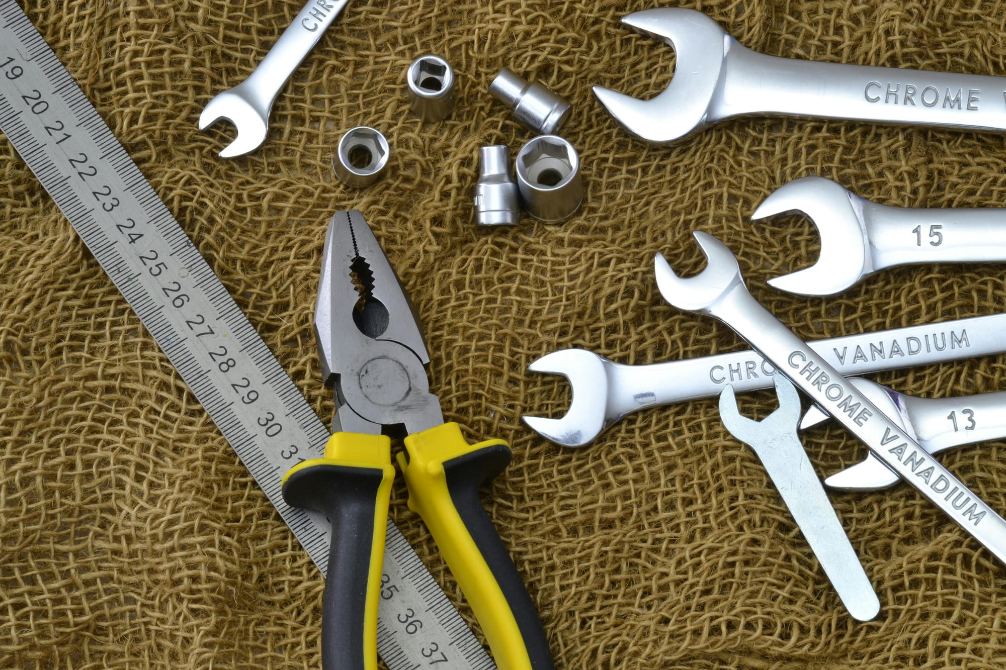 Silver Metal Tools on Brown Mesh Materia