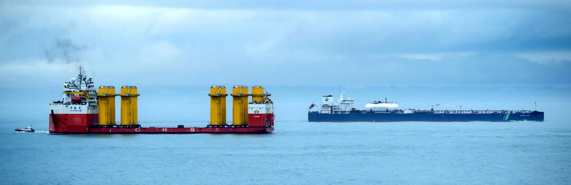 Two cargo ships in calm ocean waters