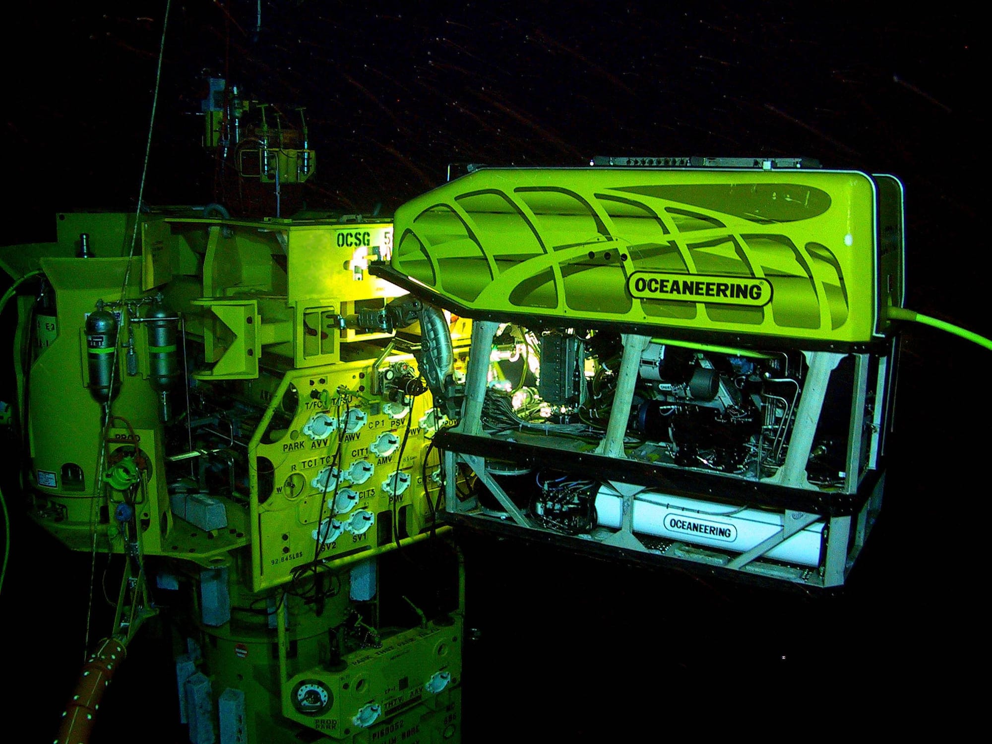 An ROV uses a torque wrench to adjust a valve in an underwater oil and gas field
