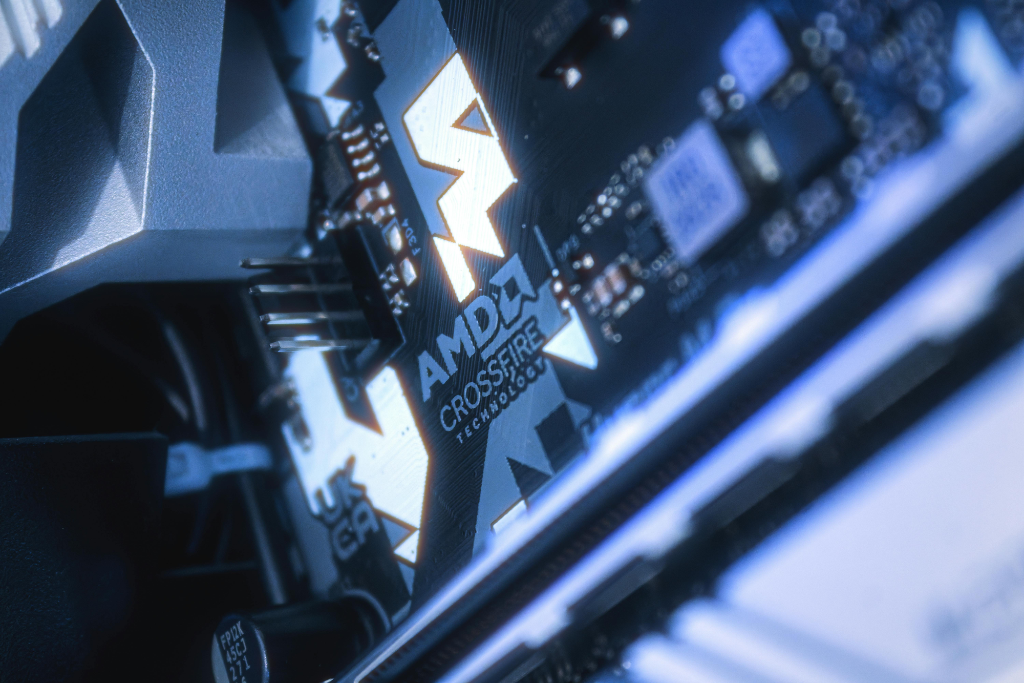 Detailed view of AMD CrossFireX technology on a motherboard, showcasing modern computing hardware.