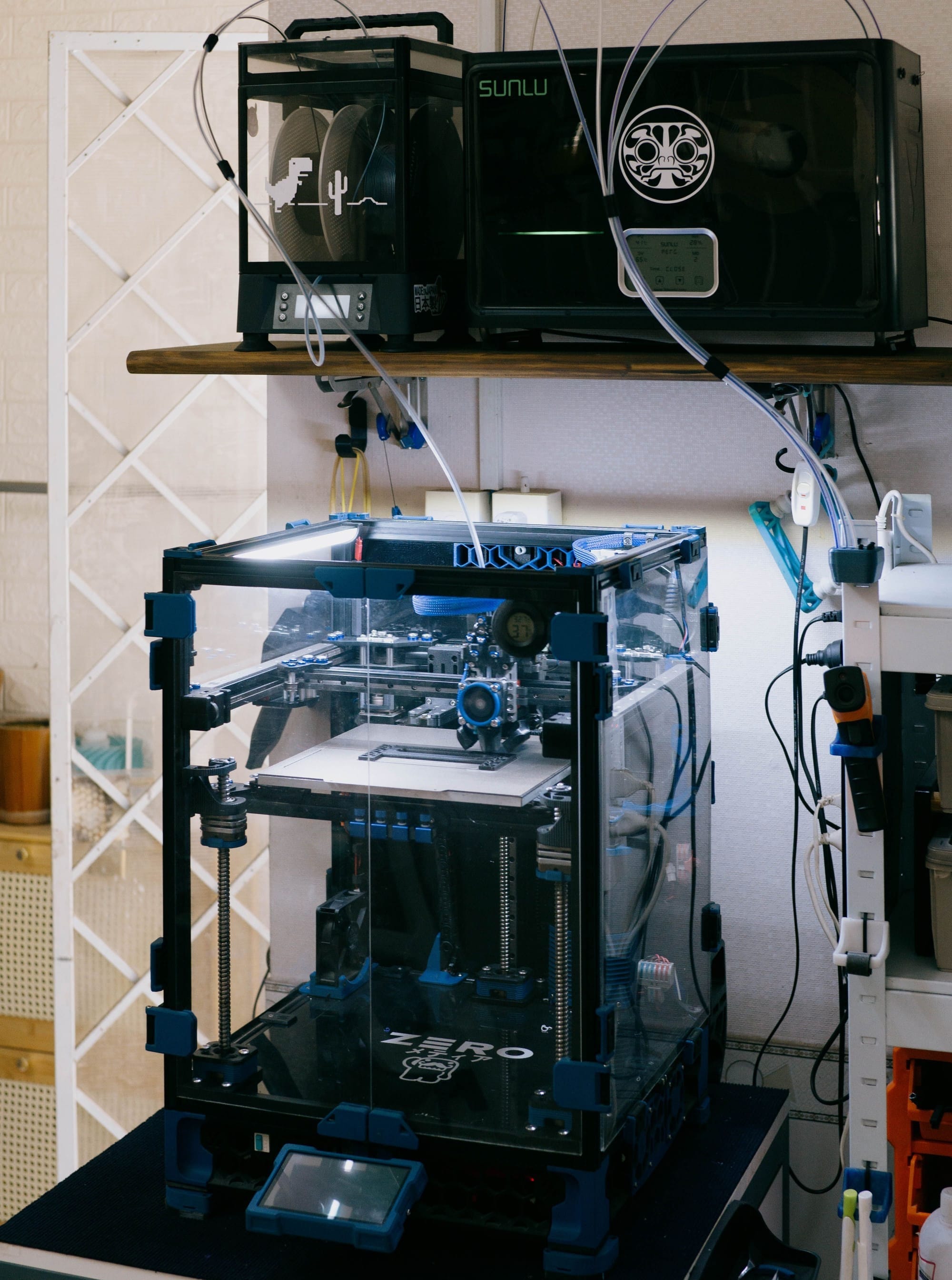 A 3D printer setup in a technology workshop with various tools and devices.