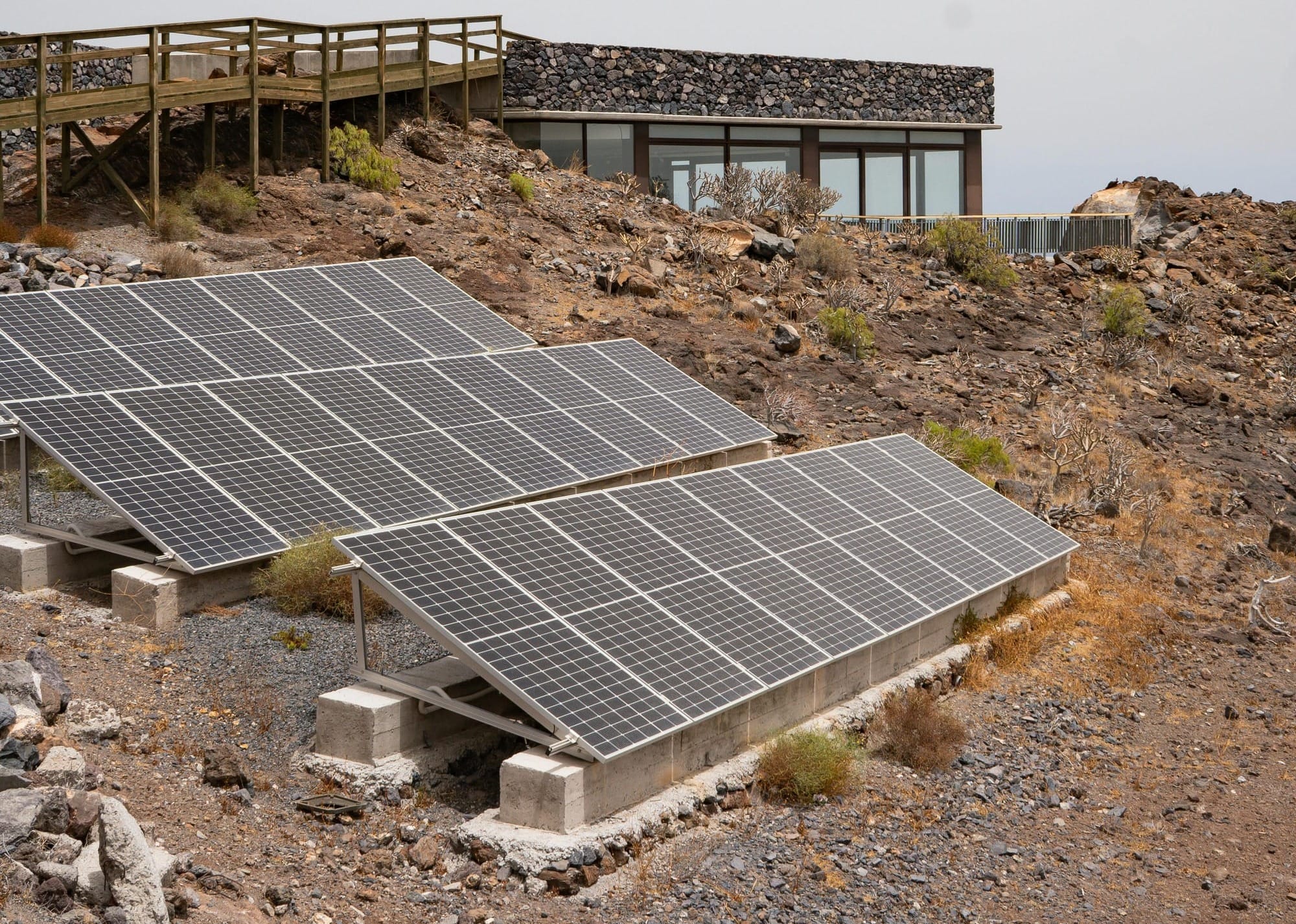 Solar panels installed on a rocky hillside showcasing renewable energy in Spain.