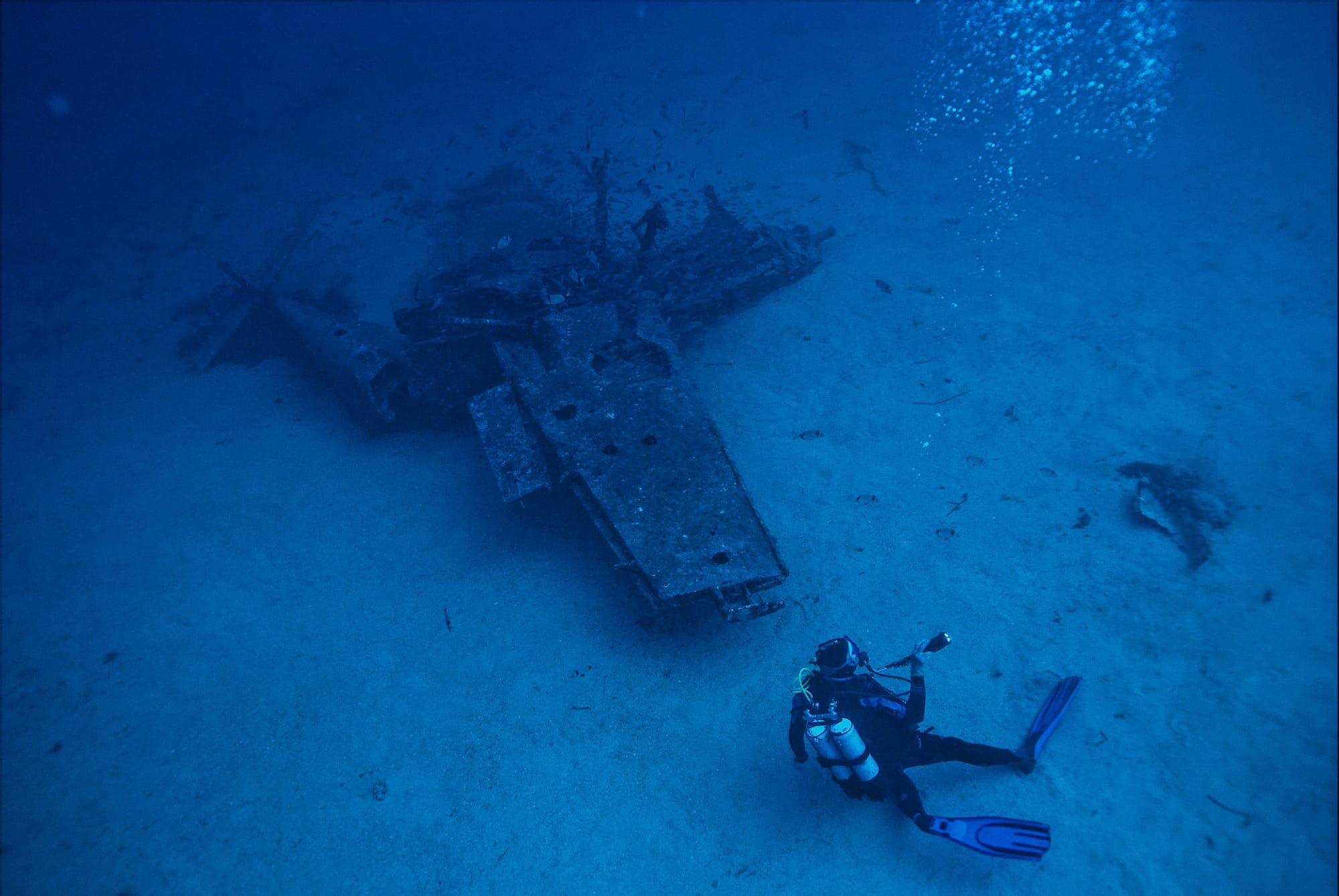 Scuba Diver Explores Submerged WW2 Aircraft