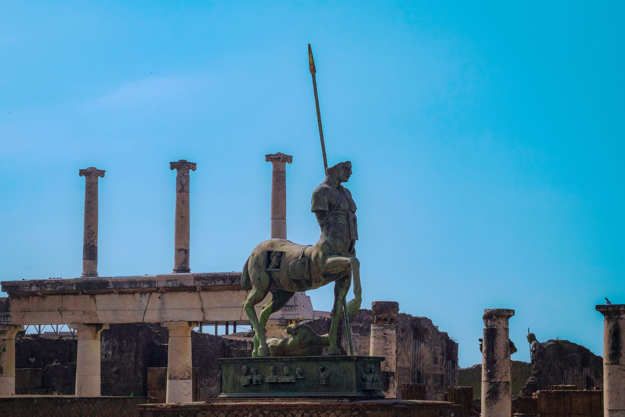 Ancient statue of a centaur amidst the ruins in Pompeii under a clear blue sky. by Ian&nbsp;MacKay