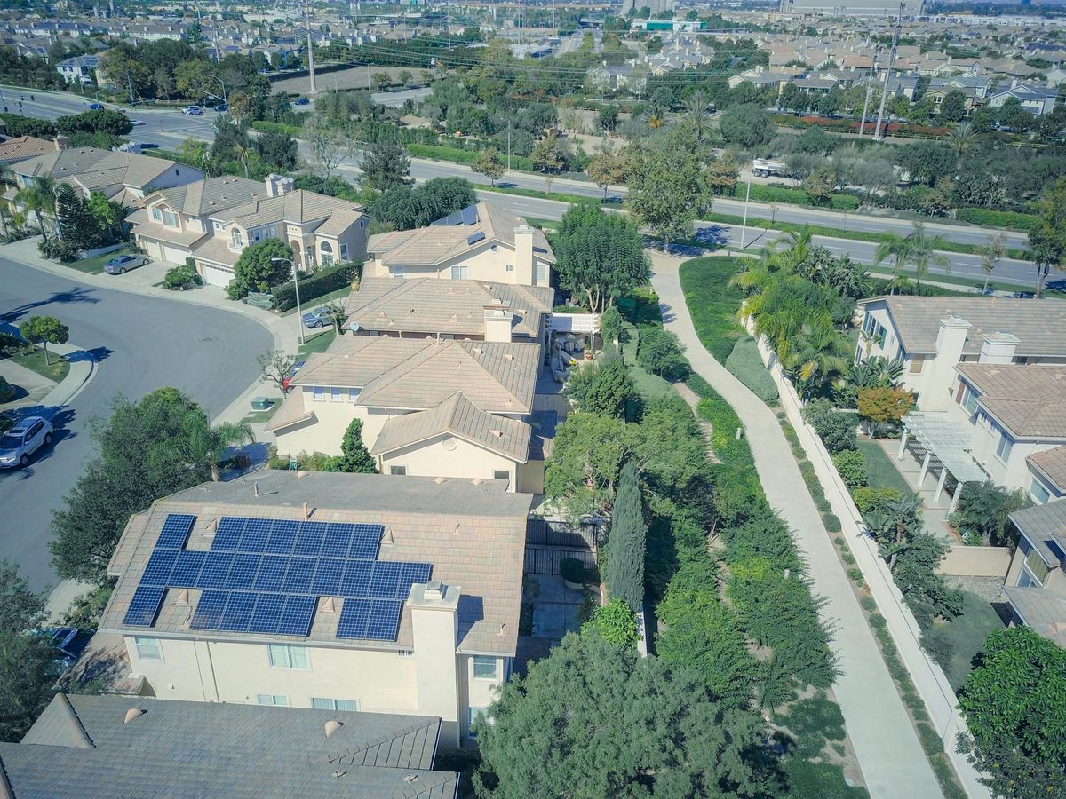 Aerial View of Suburban Village with Solar Rooftop