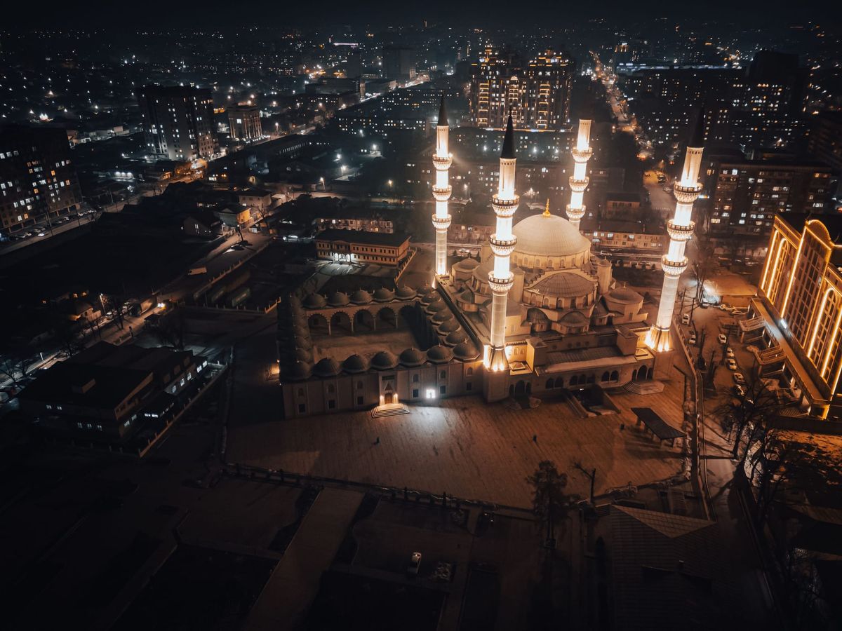  Stunning aerial view of an illuminated mosque in Bishkek City, Kyrgyzstan at night. by Collab Media