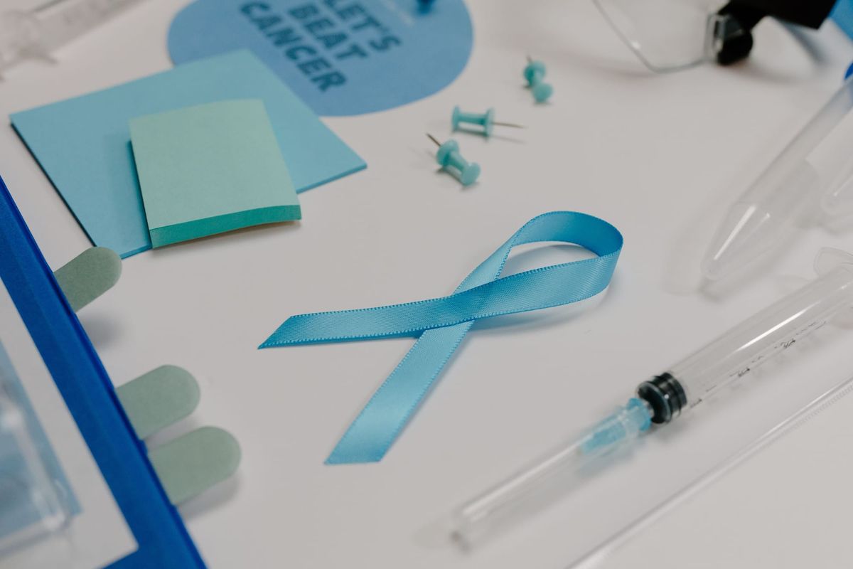 Blue ribbon with medical supplies symbolizes healthcare awareness and cancer support