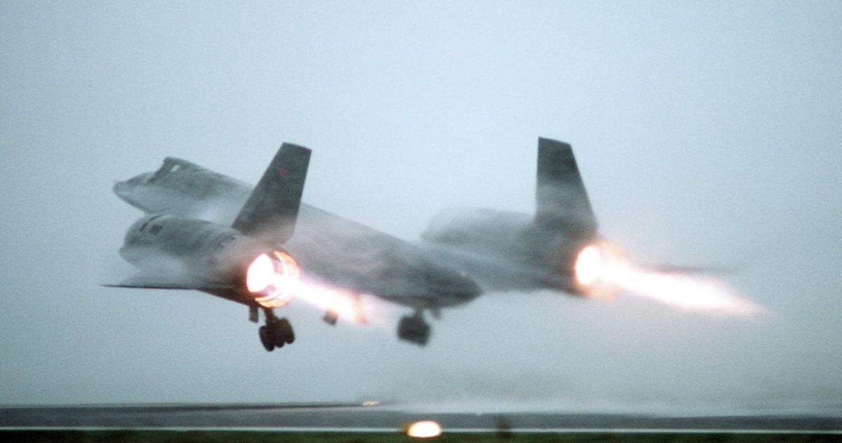 A U.S. Air Force Lockheed SR-71A Blackbird taking off from a fog-shrouded runway.