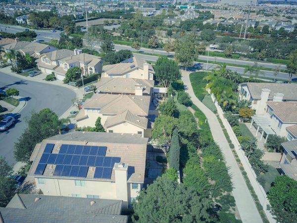 Aerial View of Suburban Village with Solar Rooftop
