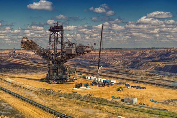 Heavy machinery operating in a vast open-pit mine