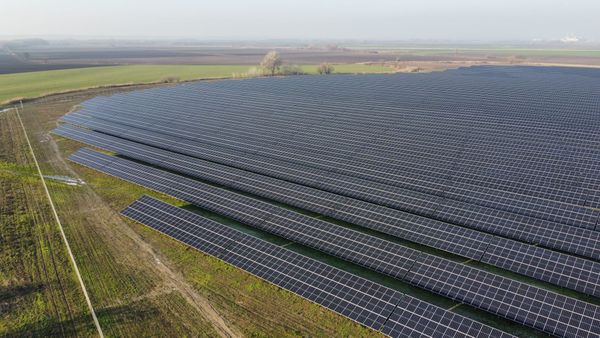 solar panel farm in a rural landscape under clear skies