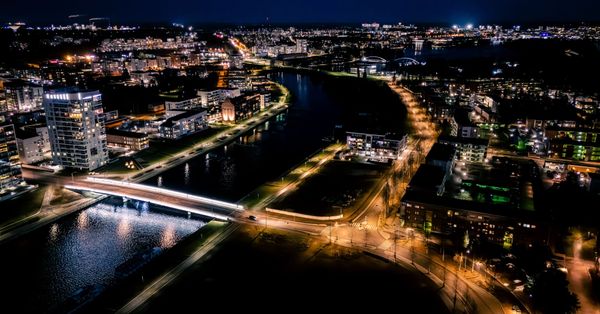 Stunning aerial view of a Finnish cityscape illuminated at night.