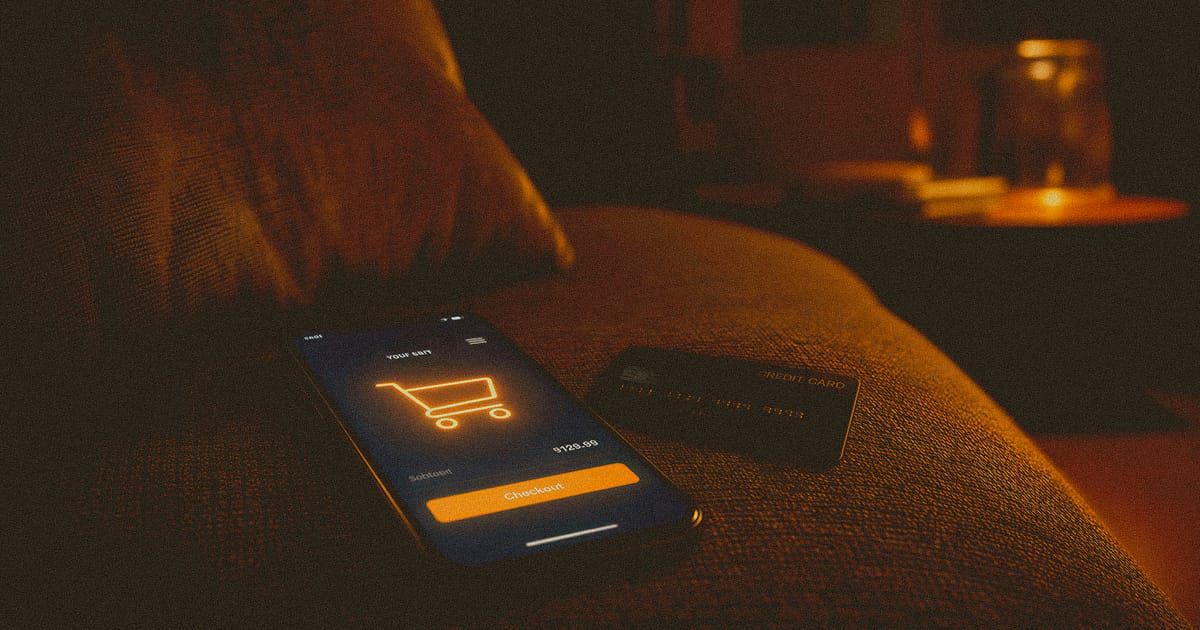 A phone showing a shopping cart glowing in a dim room, with a credit card nearby, capturing the suspended moment before an impulse purchase.