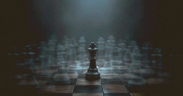 A chess king surrounded by overlapping ghostly duplicate pieces in different positions, representing the paralysis of overthinking every possible move.