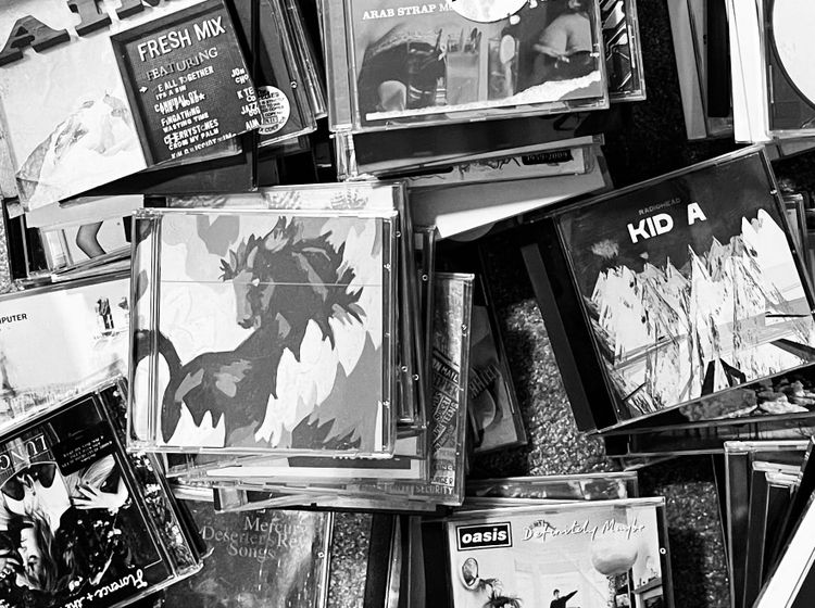 Various piles of compact discs