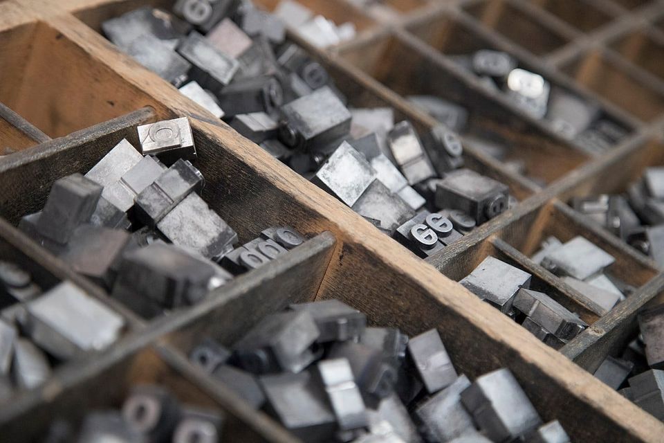 Close up photo of lower case lettering in a typesetter tray