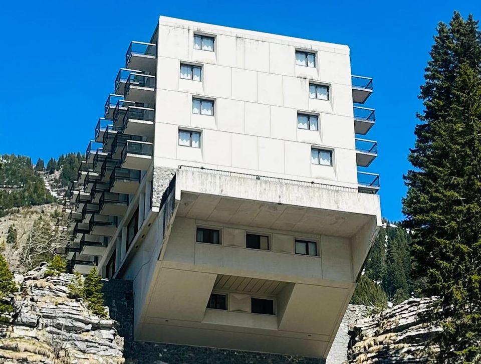 A building jutting out over a French cliff edge