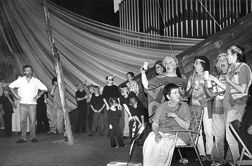 AS IN A COMMUNITY BARN-RAISING