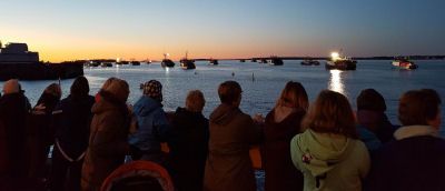 A CROWD WATCHES