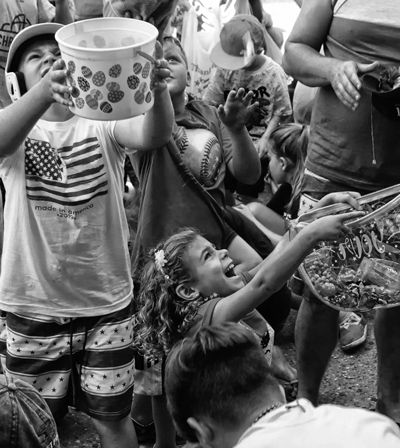 Children found novel ways to collect candy and protect their heads during the Penny Scramble.